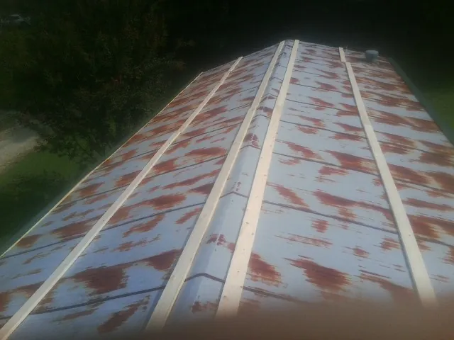 Rusted metal roof panels with new wood purlins before replacement — Storm Damage Roof Repair in Evant by Roofing Brothers